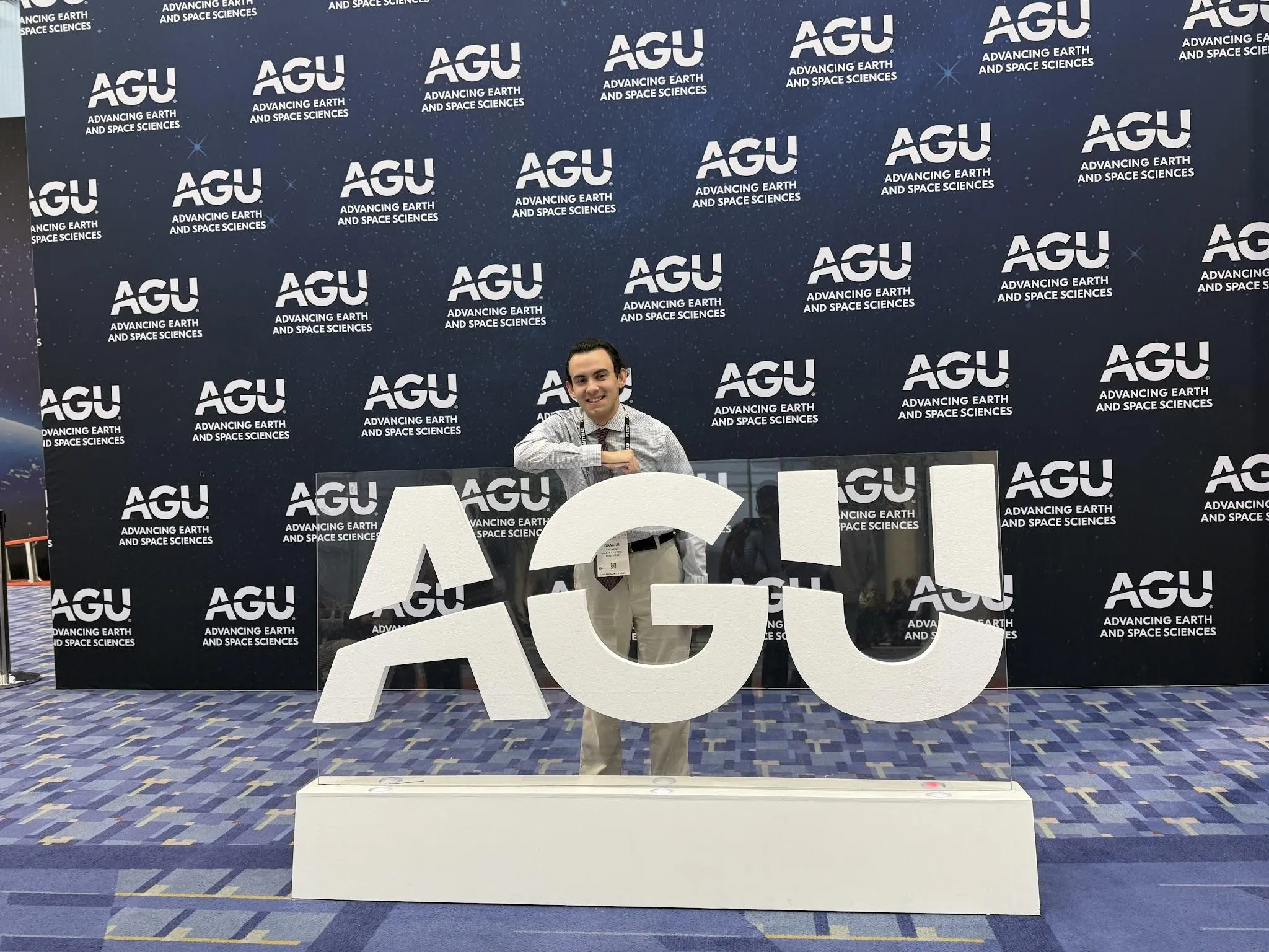 D.J. at the AGU 2024 sign.