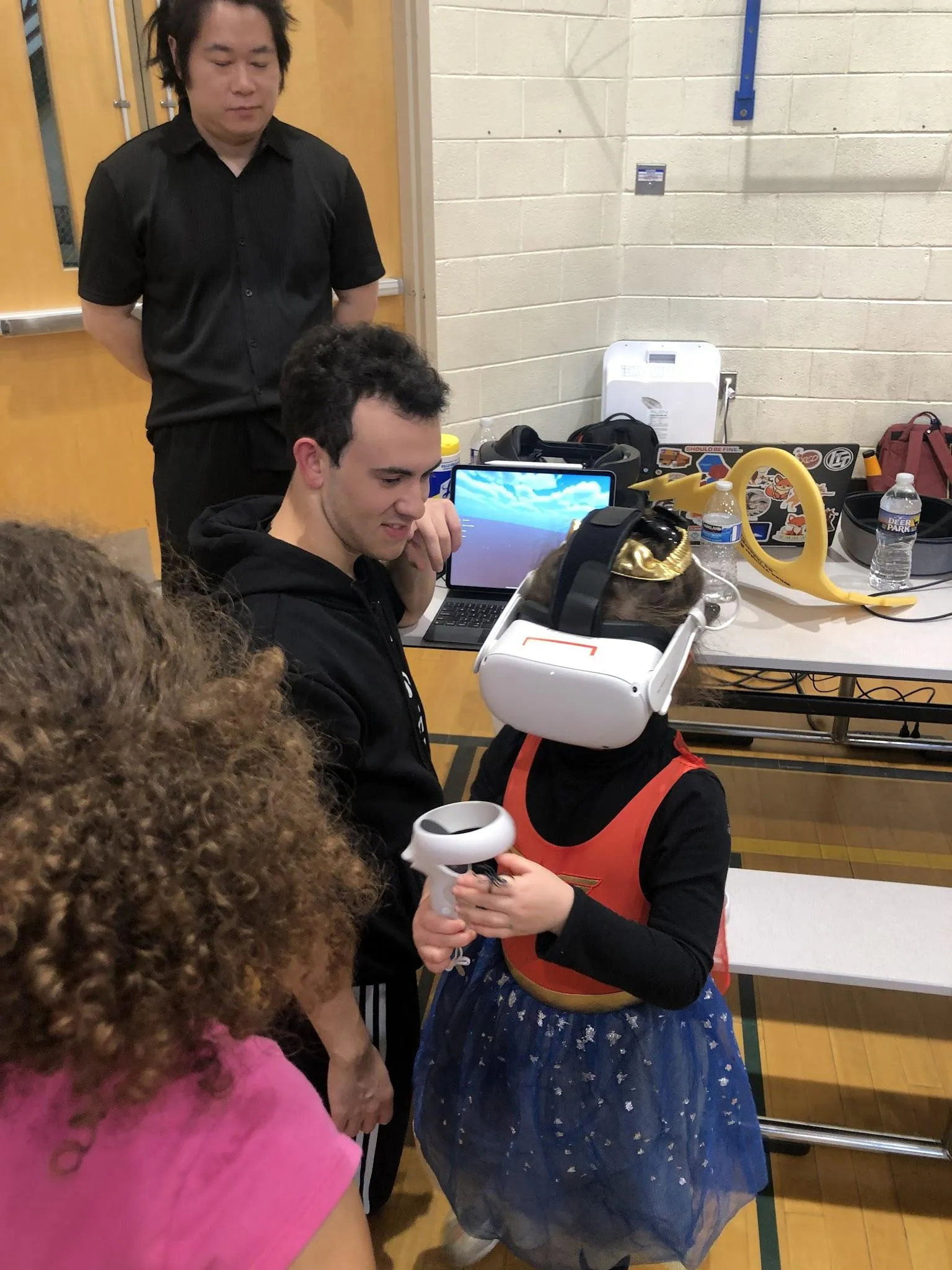 D.J. guiding a small girl through Ashmita's Faraday Lightning Safety module