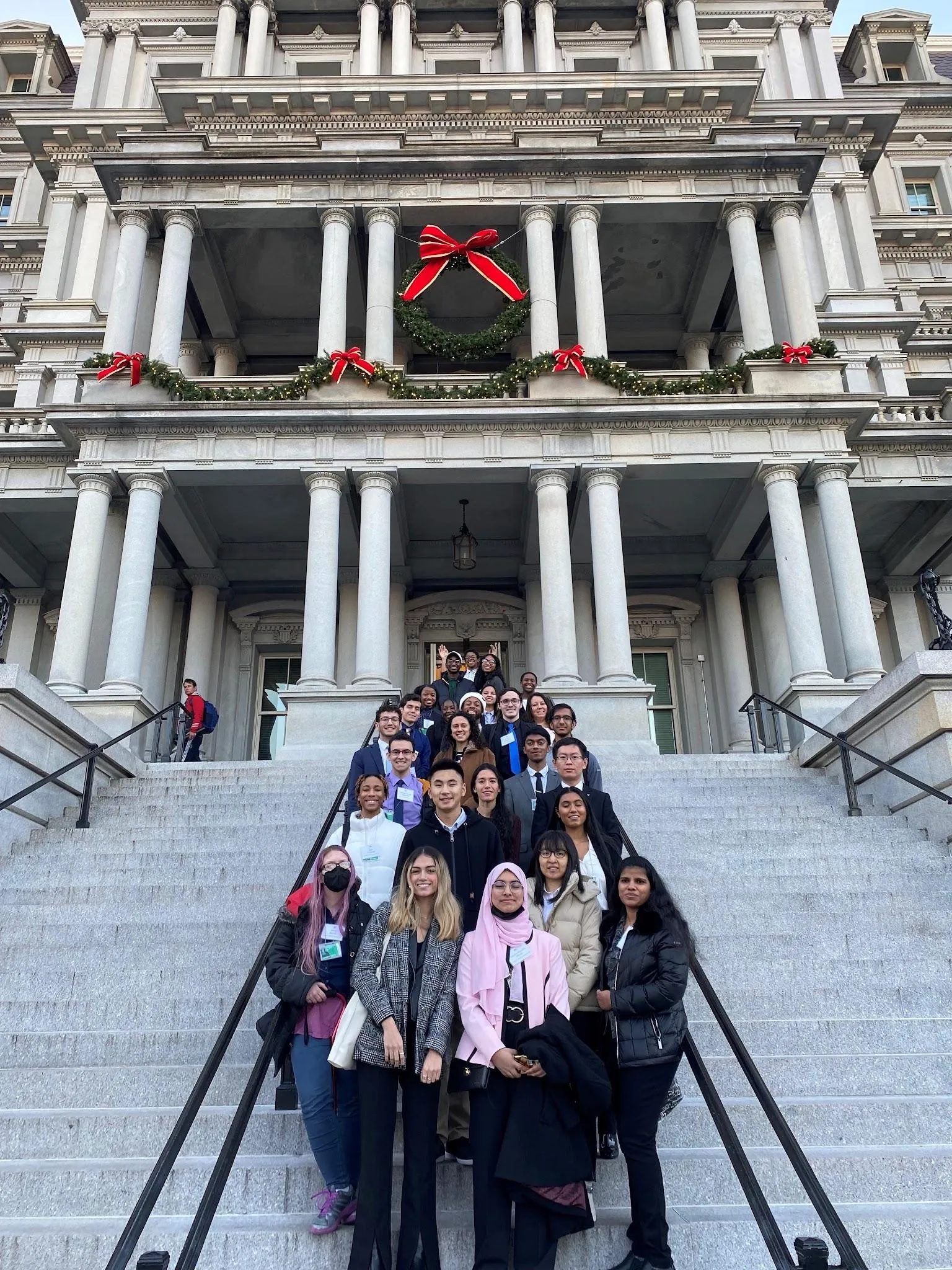 All the round table participants on the White House executive building stairs.